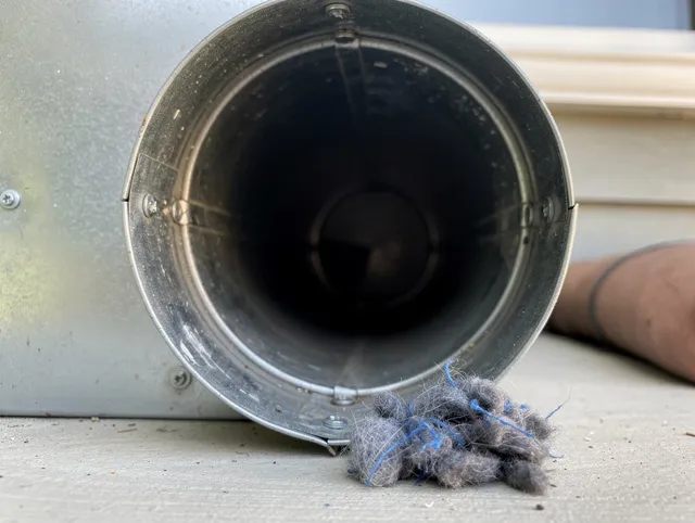 Wilmington Island Dryer Vent Cleaning technician using specialized equipment to clear severe dryer vent blockage in Wilmington Island